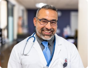A doctor smiling at the camera.